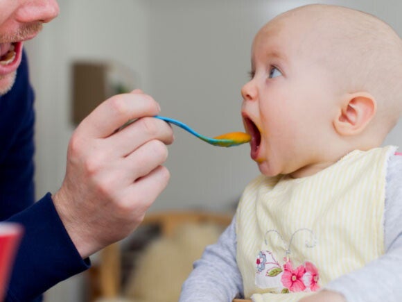 Dad feeding baby