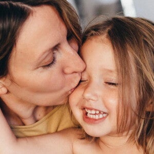 Mom kissing her baby girl