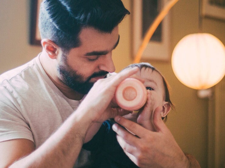 Dad bottle feeding his baby