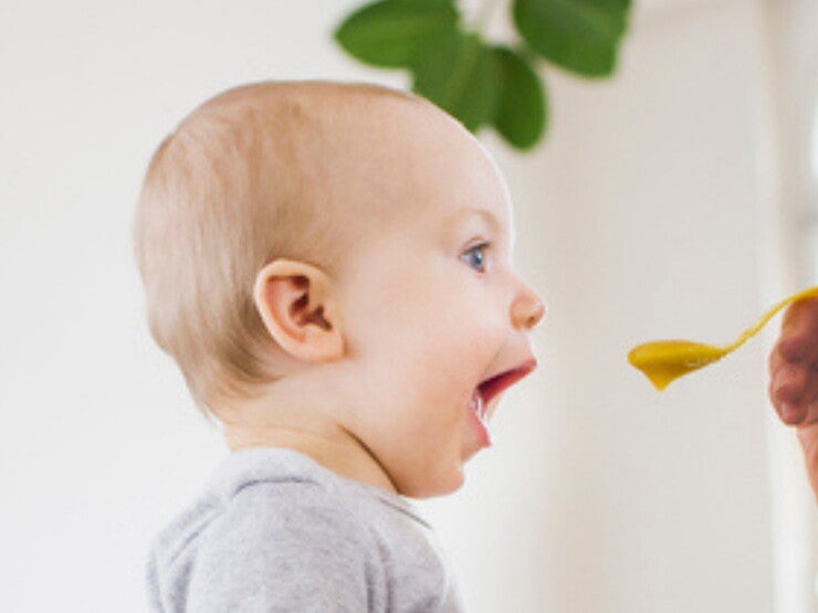 Mom feeding her baby with a spoon