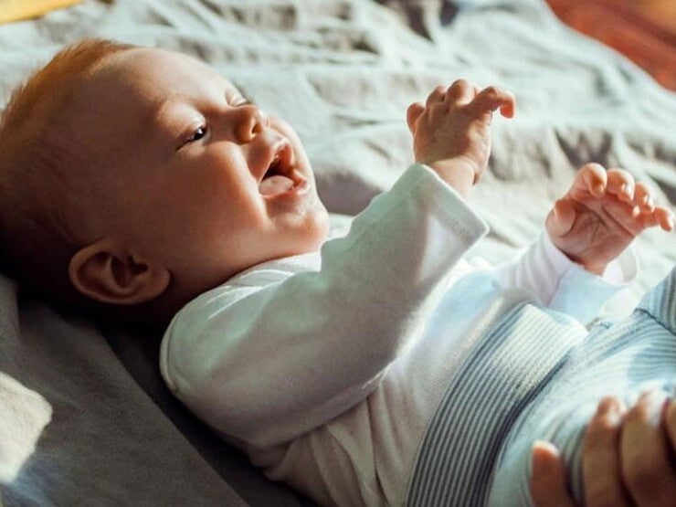 Mom kissing baby's toe