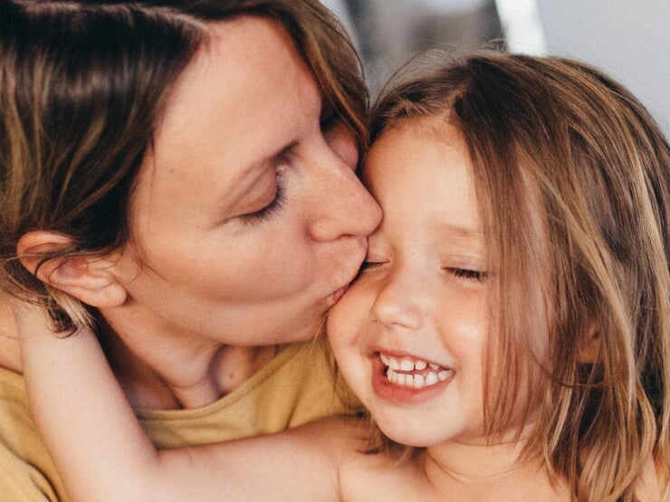 Mom kissing her baby girl Mom kissing her baby girl